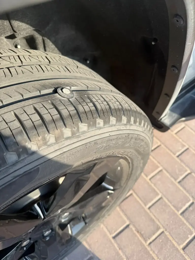 Real tyre puncture inspection showing a nail in the tread